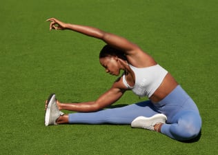 Woman does a seated stretch