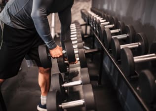 man selecting weight at the gym