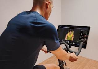 man taking one of peloton's best cycling class on bike