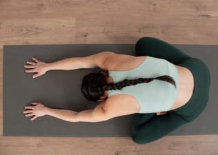 Aerial view of woman sitting on a yoga mat