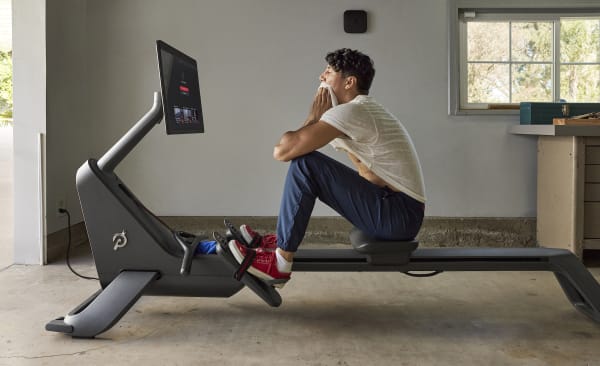Man looks at his split time after finishing a rowing workout