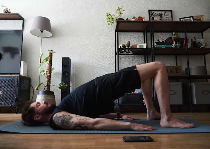 Man doing Pilates at home.