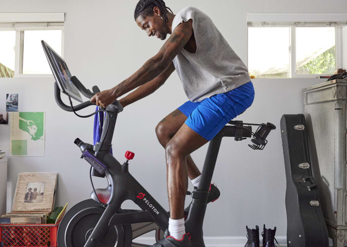 Man rides indoor Peloton Bike at home 