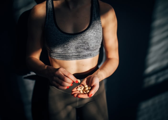 An athlete eating nuts to replenish electrolytes after a workout.
