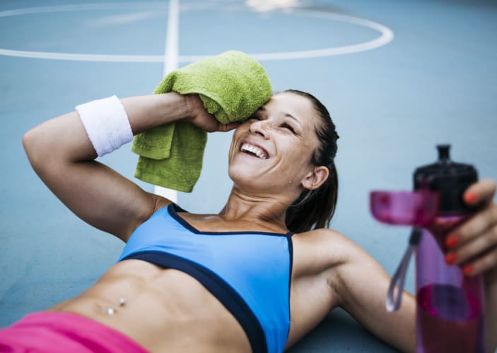 woman laying on ground after ab workout