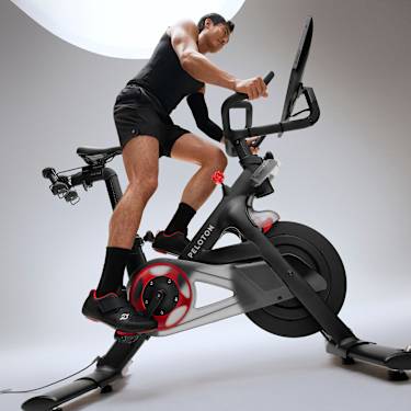 Man riding Peloton bike