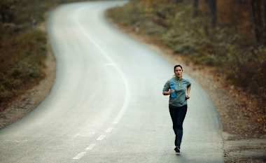 Woman running on a road