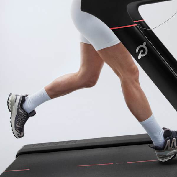 side view image of a persons legs running on Peloton Treadmill with white shorts