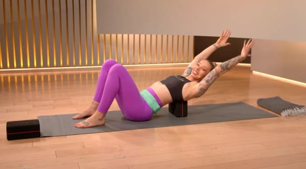 Selena Samuela on mat with dumbbell
