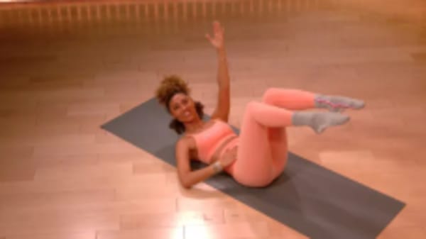 Ally Love doing ab exercise on yoga mat