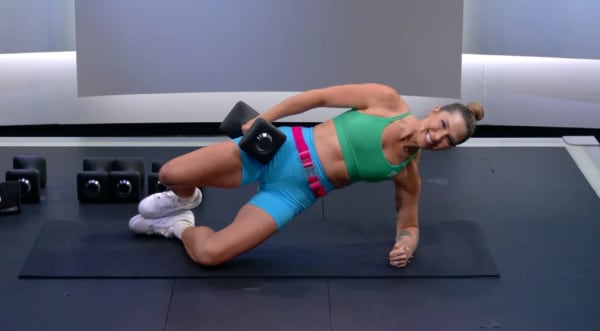 Selena Samuela on mat with dumbbell