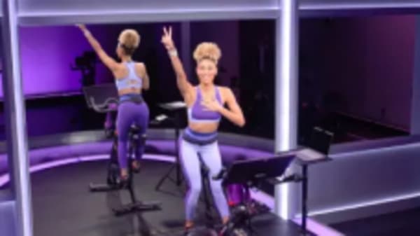 Ally Love doing workout on Peloton Bike