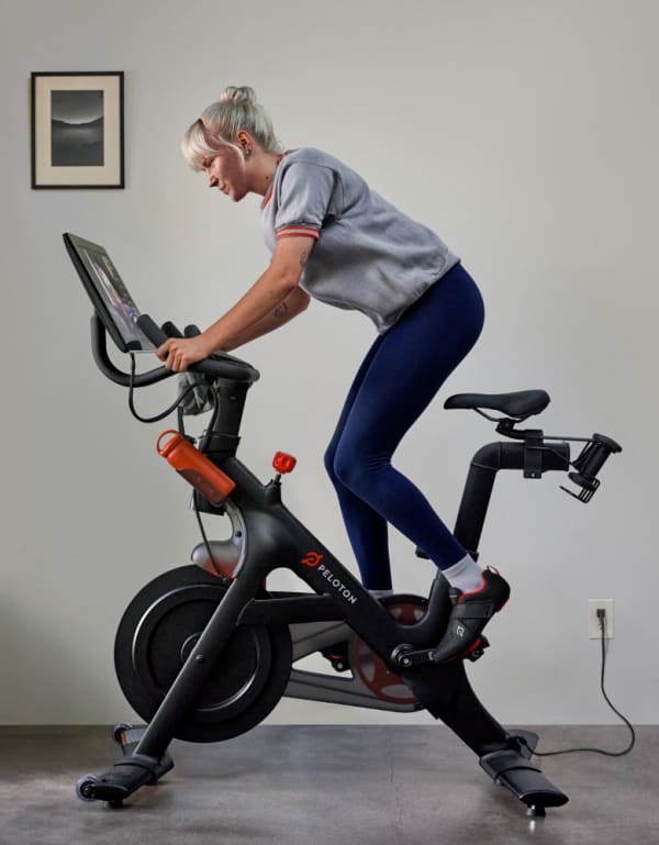 Member using Peloton Refurbished Bike