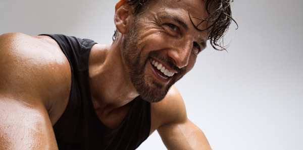 Peloton Guest Instructor Tim Robards riding Peloton Bike