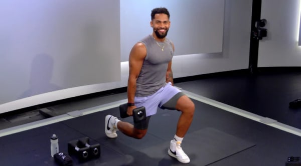 Rad Lopez doing a lunge  with Peloton dumbbells