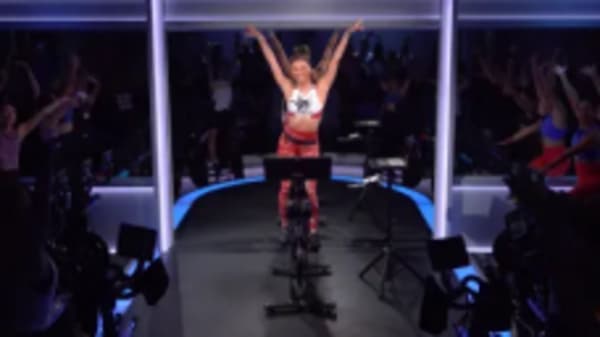 Ally Love doing workout on Peloton Bike