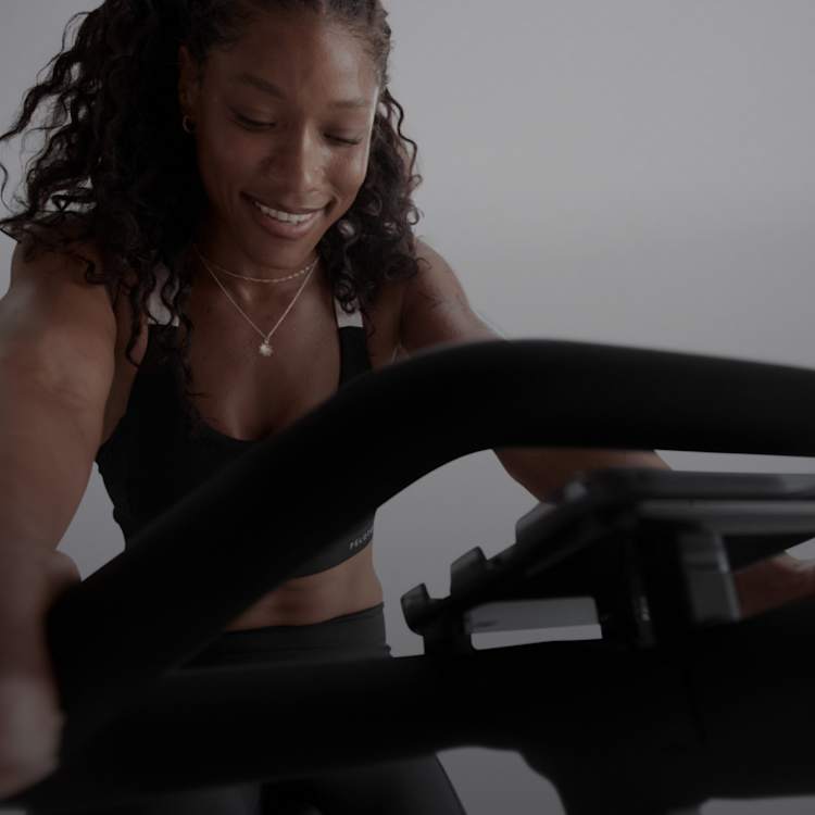 Woman riding Peloton Bike