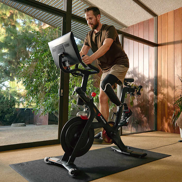 member riding peloton bike
