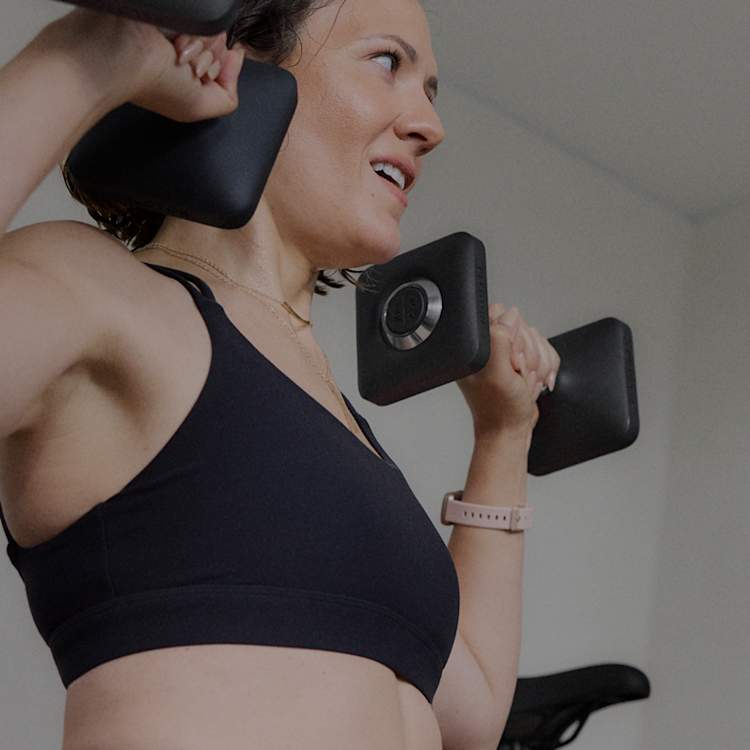 Peloton member lifting weights