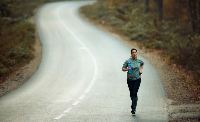 Woman running on a road