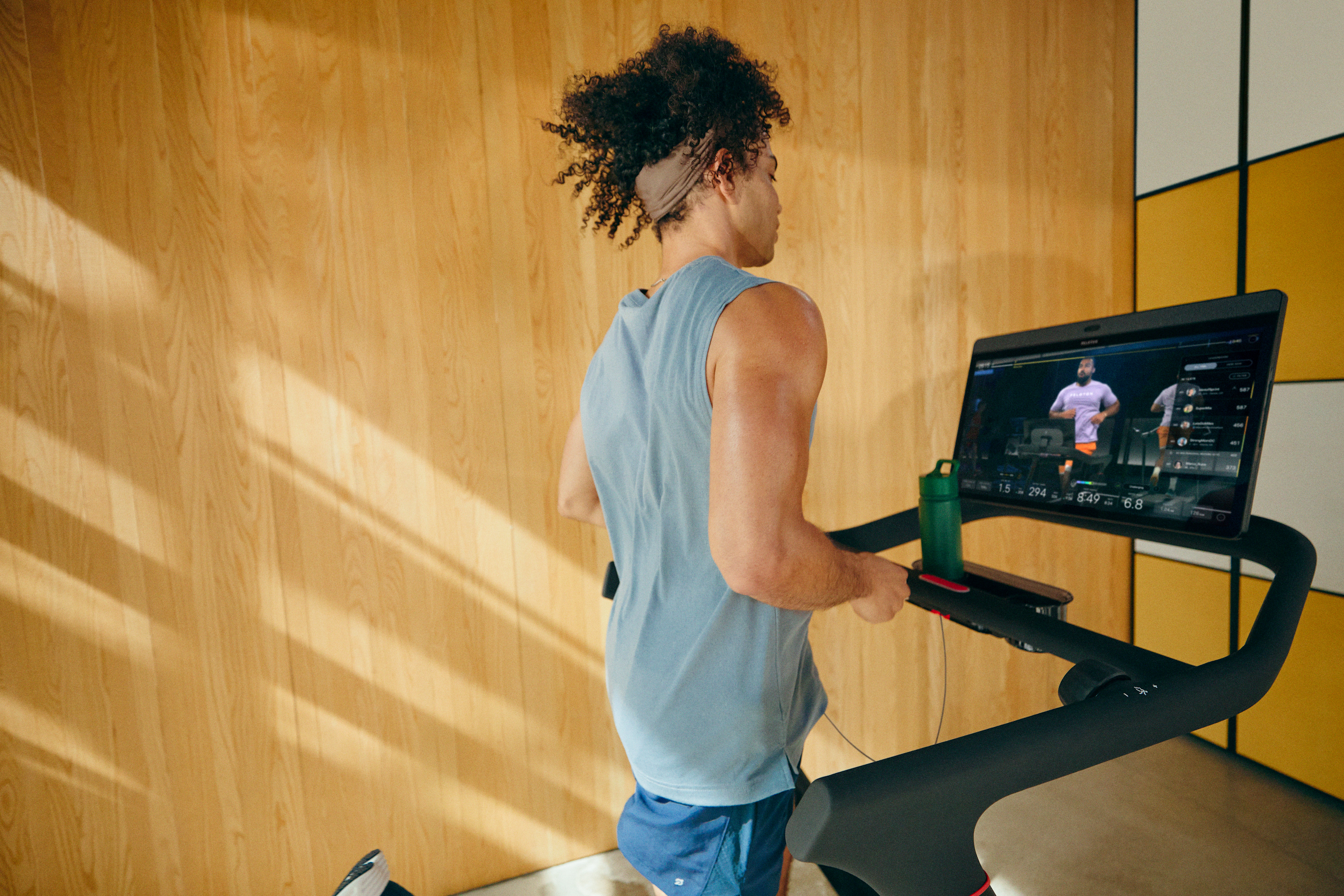 Man training for a half marathon on a Peloton treadmill.
