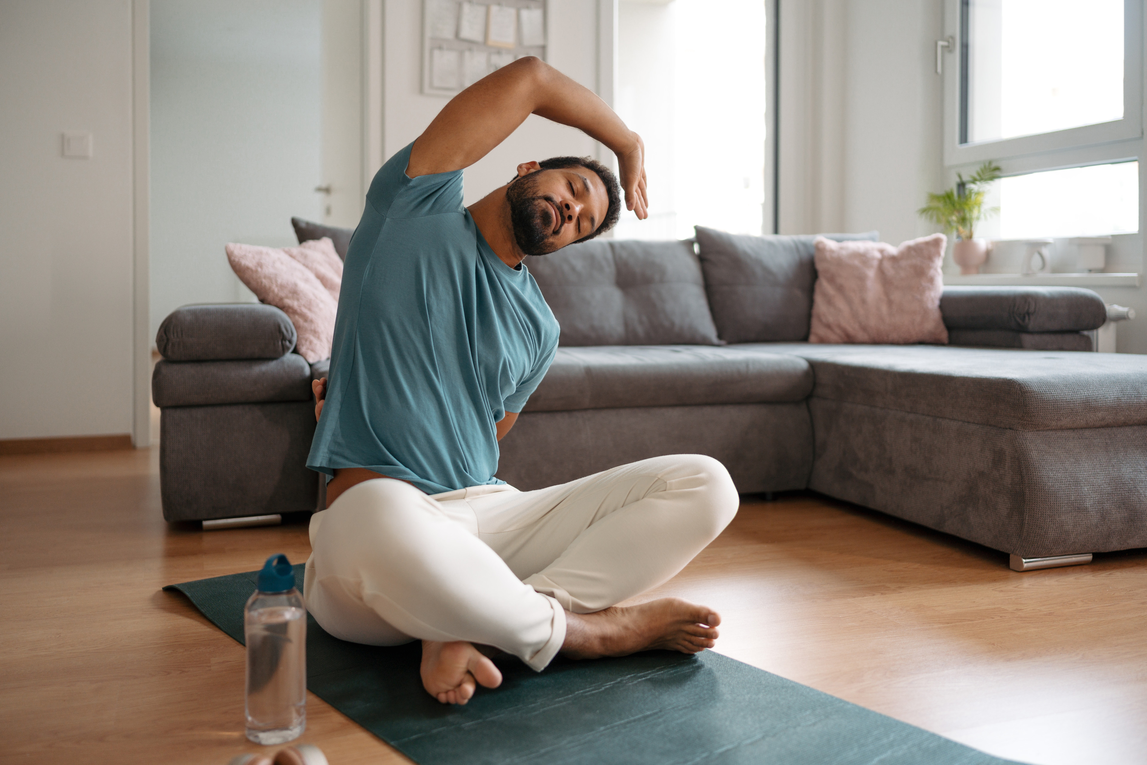 Man stretches at home 