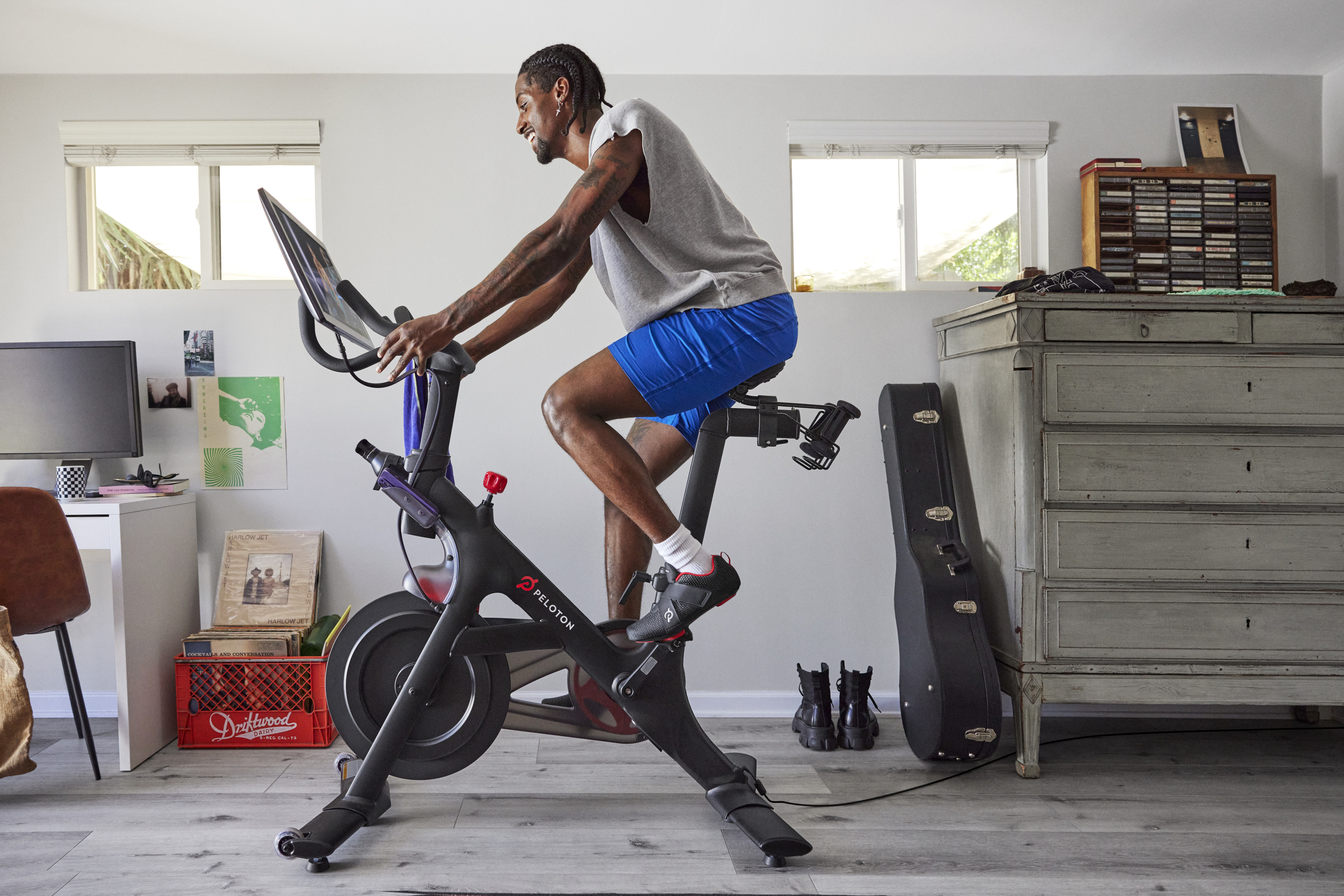 Man rides Peloton Bike at home