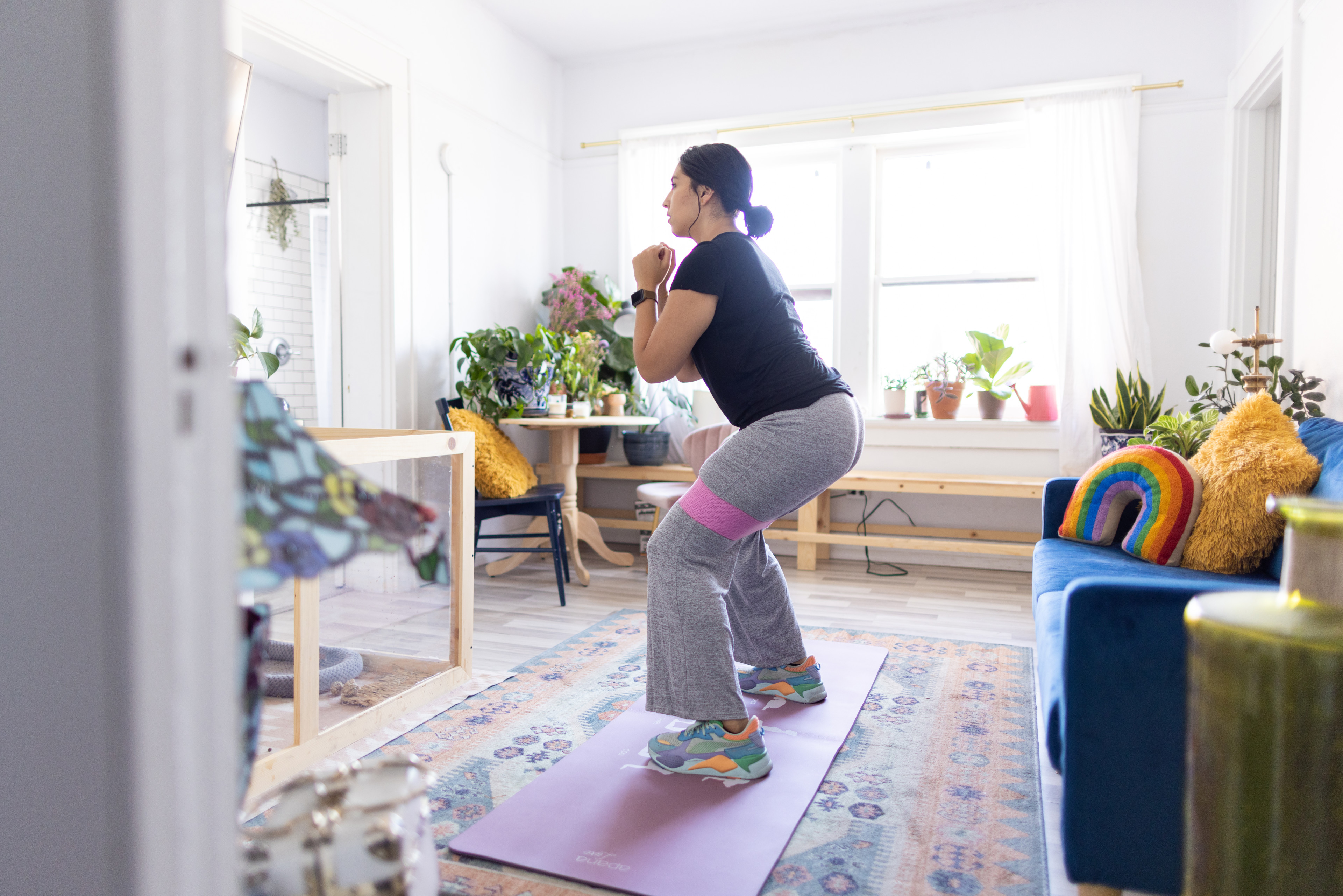 Woman does a resistance band exercise at home