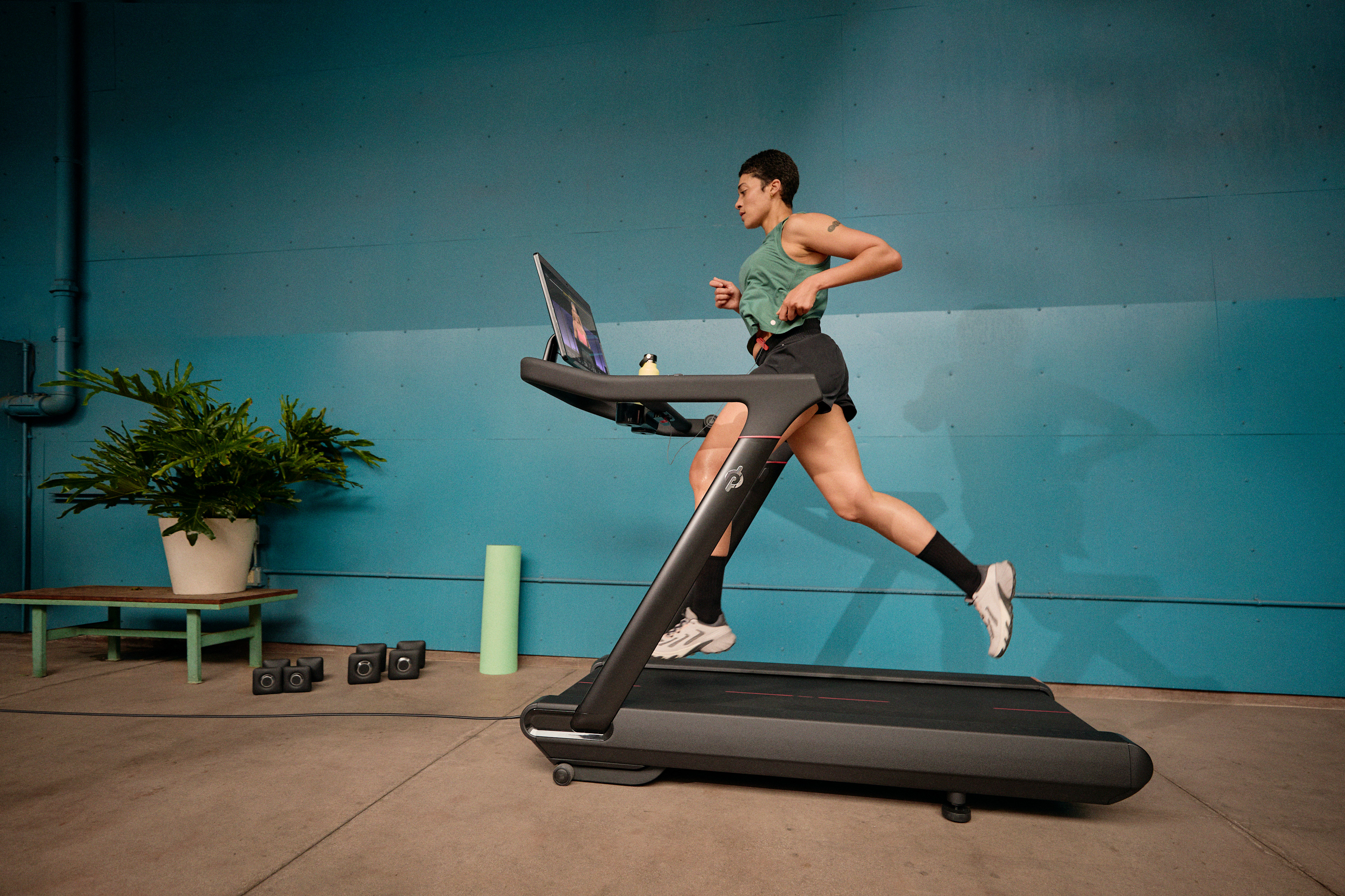 Person doing speed work running on a Peloton treadmill