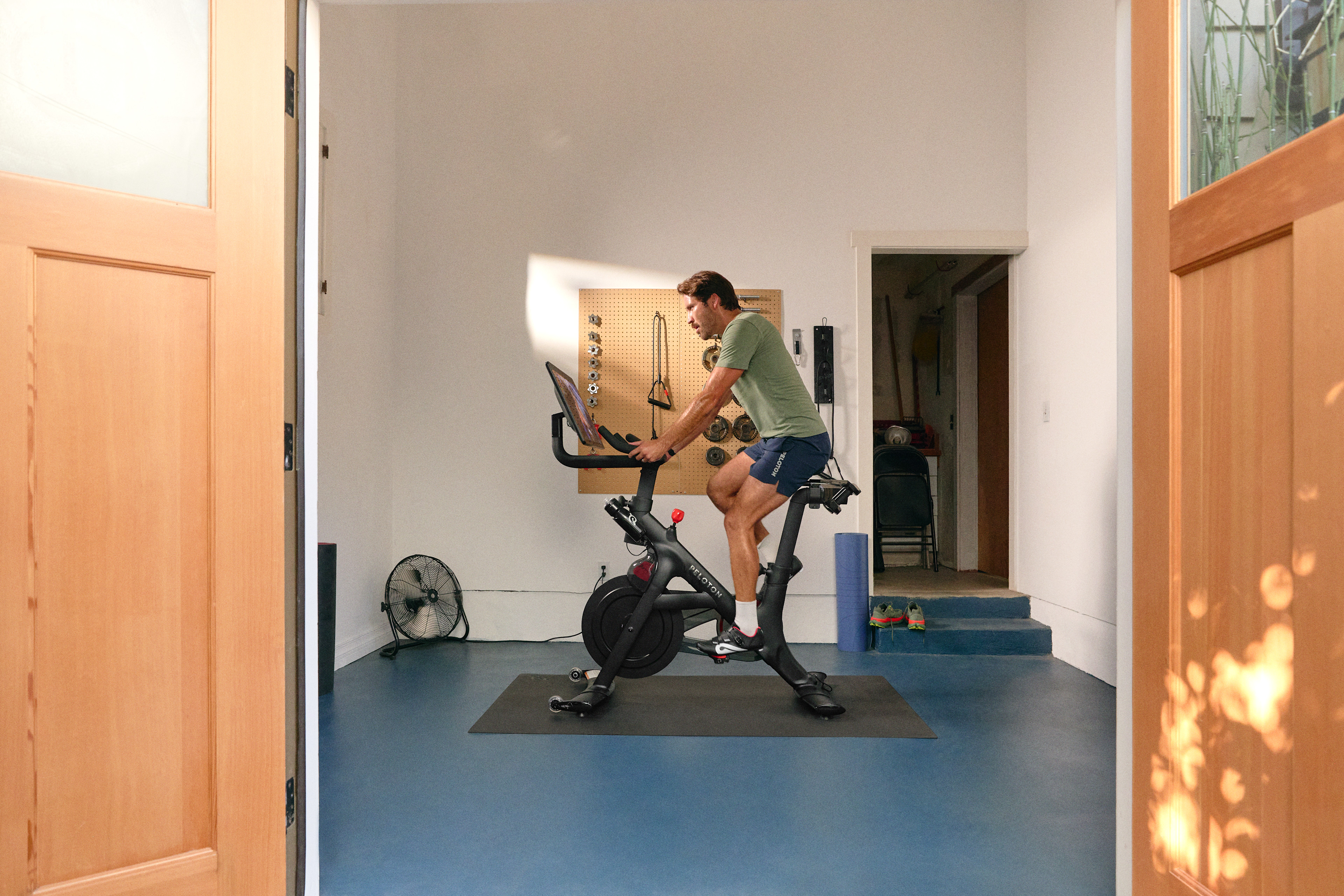 Man on a Peloton Bike+ doing light cardio on a rest day.