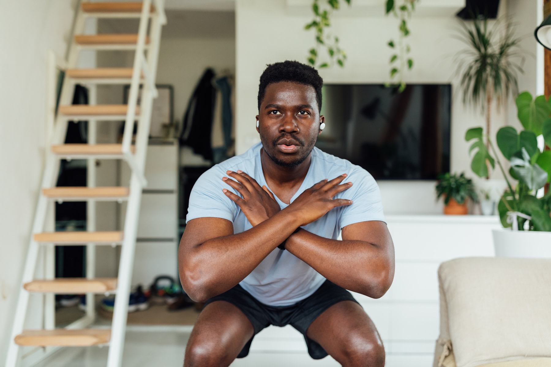 Man does a squat, practicing strength training exercises for triathletes