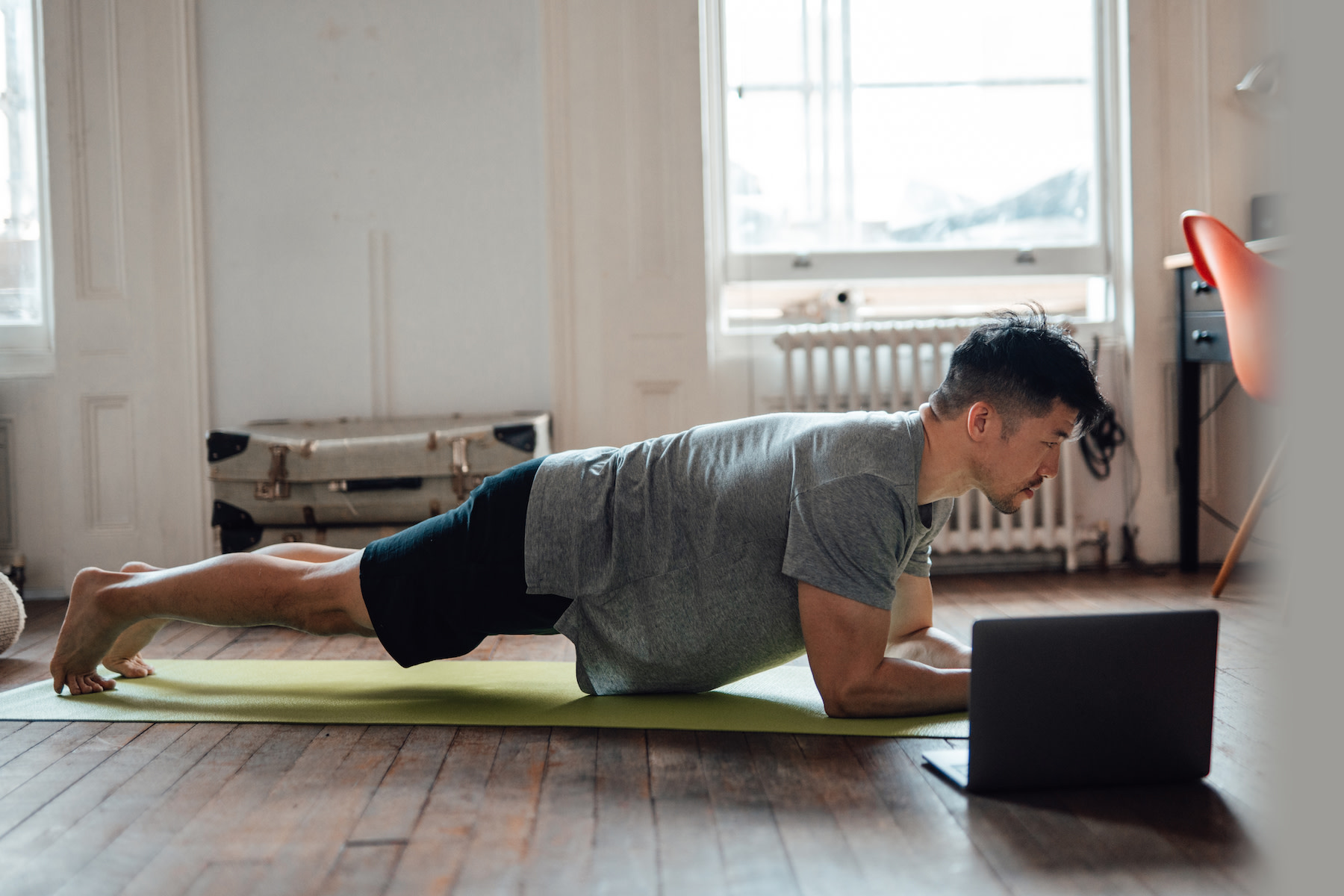Man demonstrates how to engage your core while doing a plank