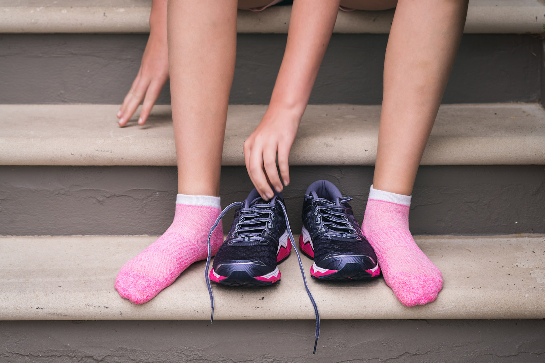 Woman tries on a pair on running shoes