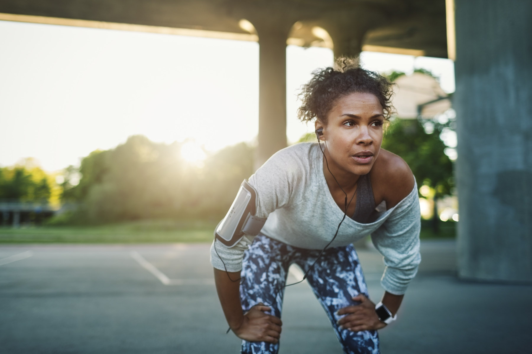 A runner taking a break from her outdoor jog as she suffers from social jet lag. 