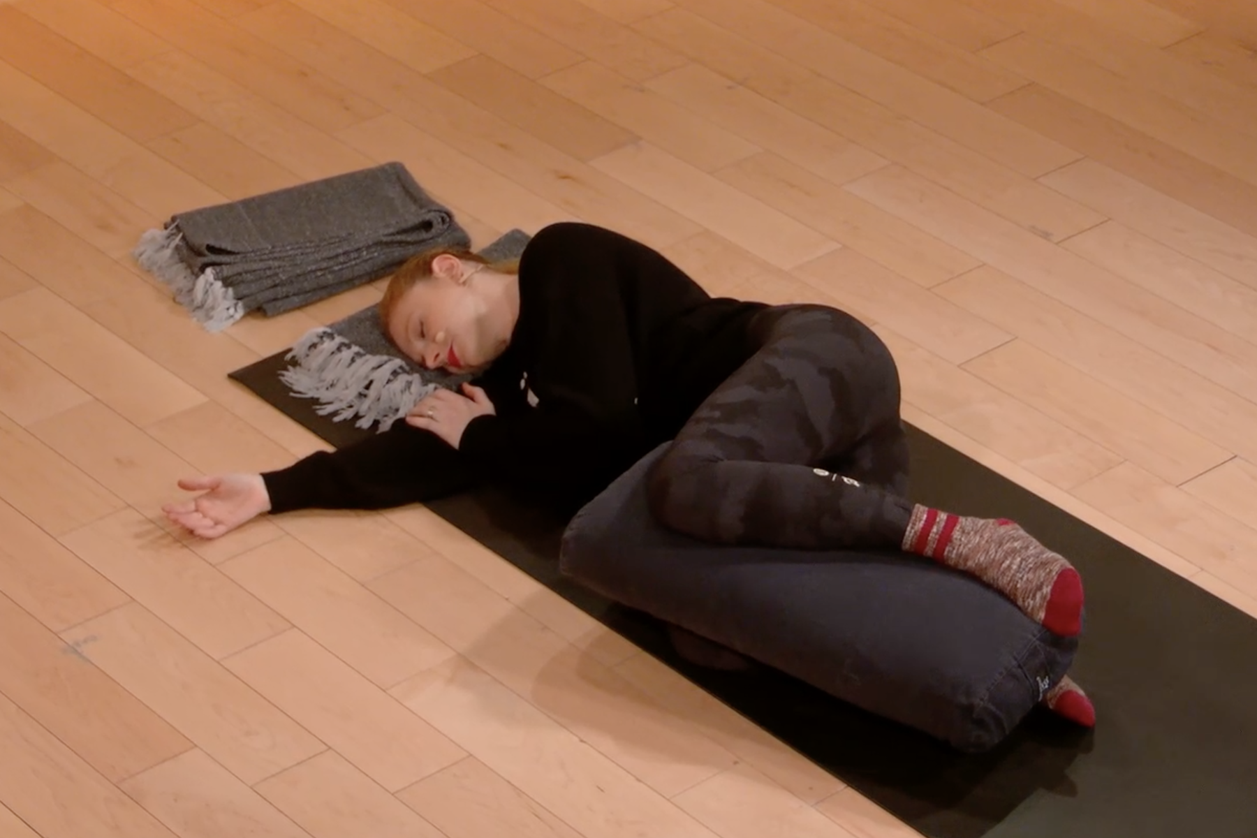 Woman does a restorative yoga pose