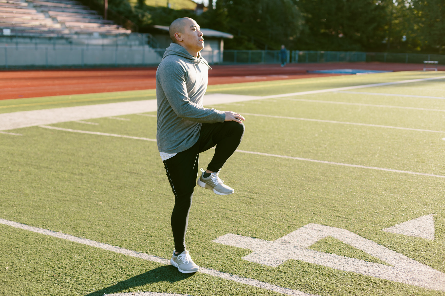 Man doing high knees on football field