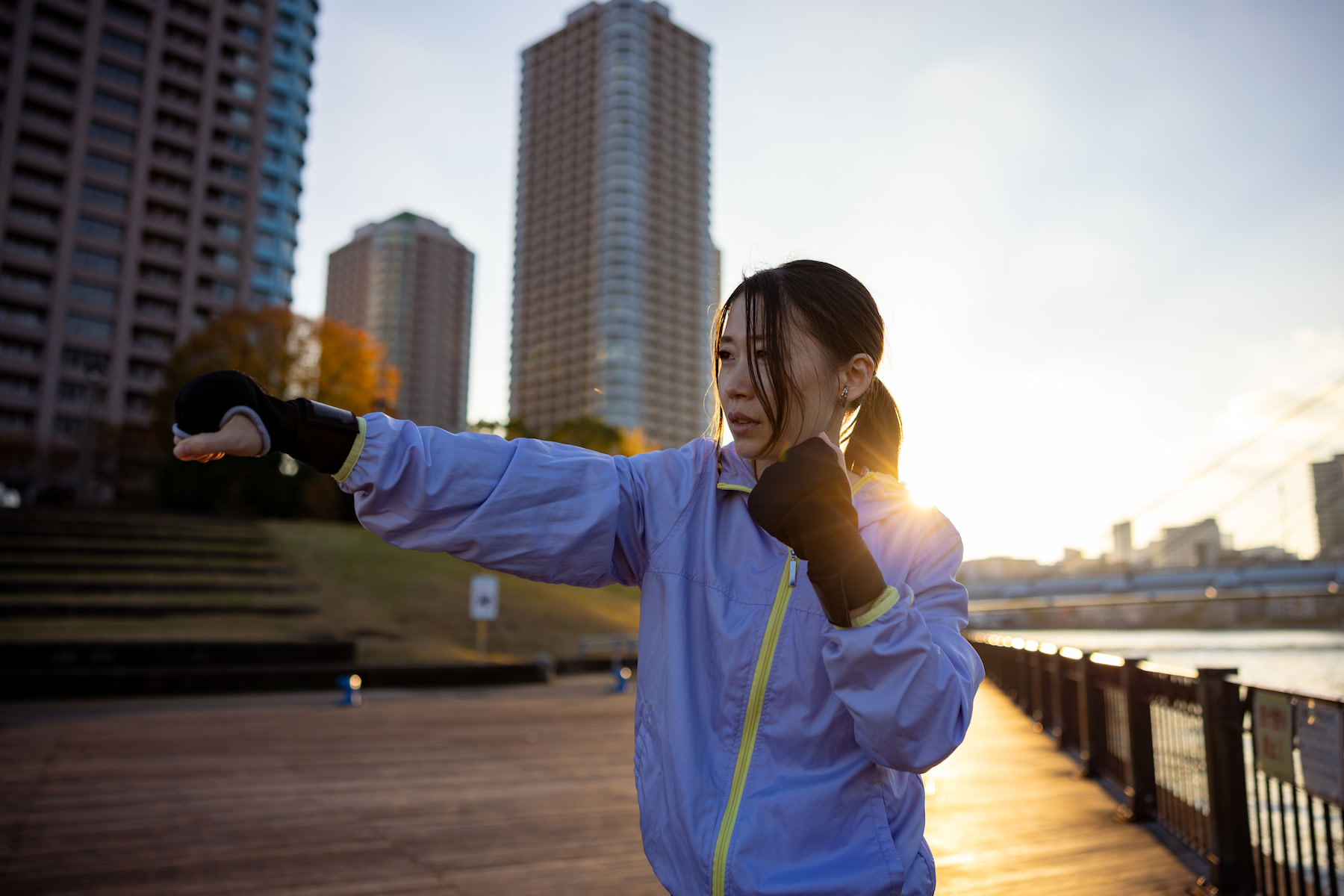 Woman shadowboxes outside on the river, what is shadowboxing