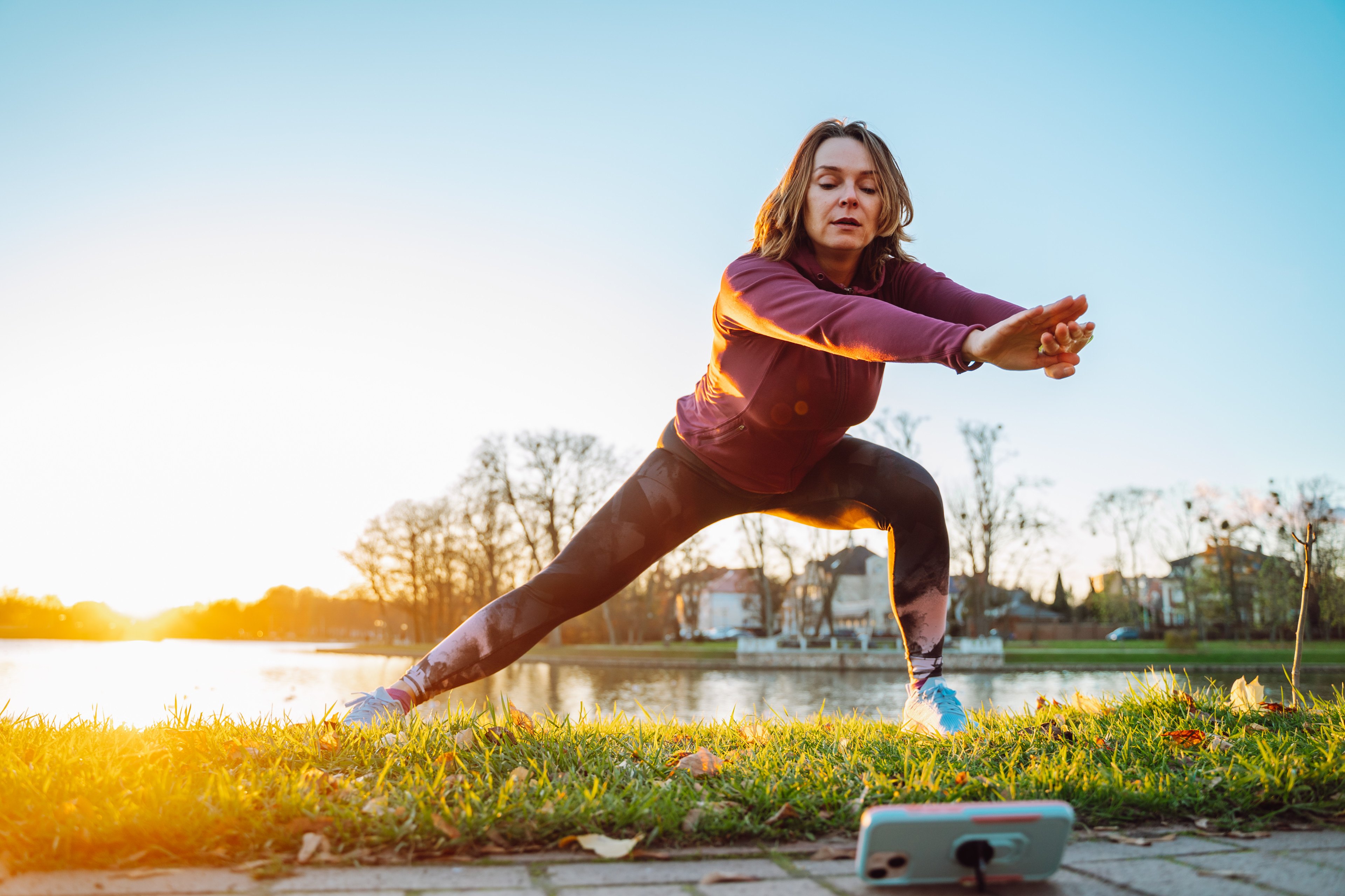 Woman does a lunge exercise outdoors