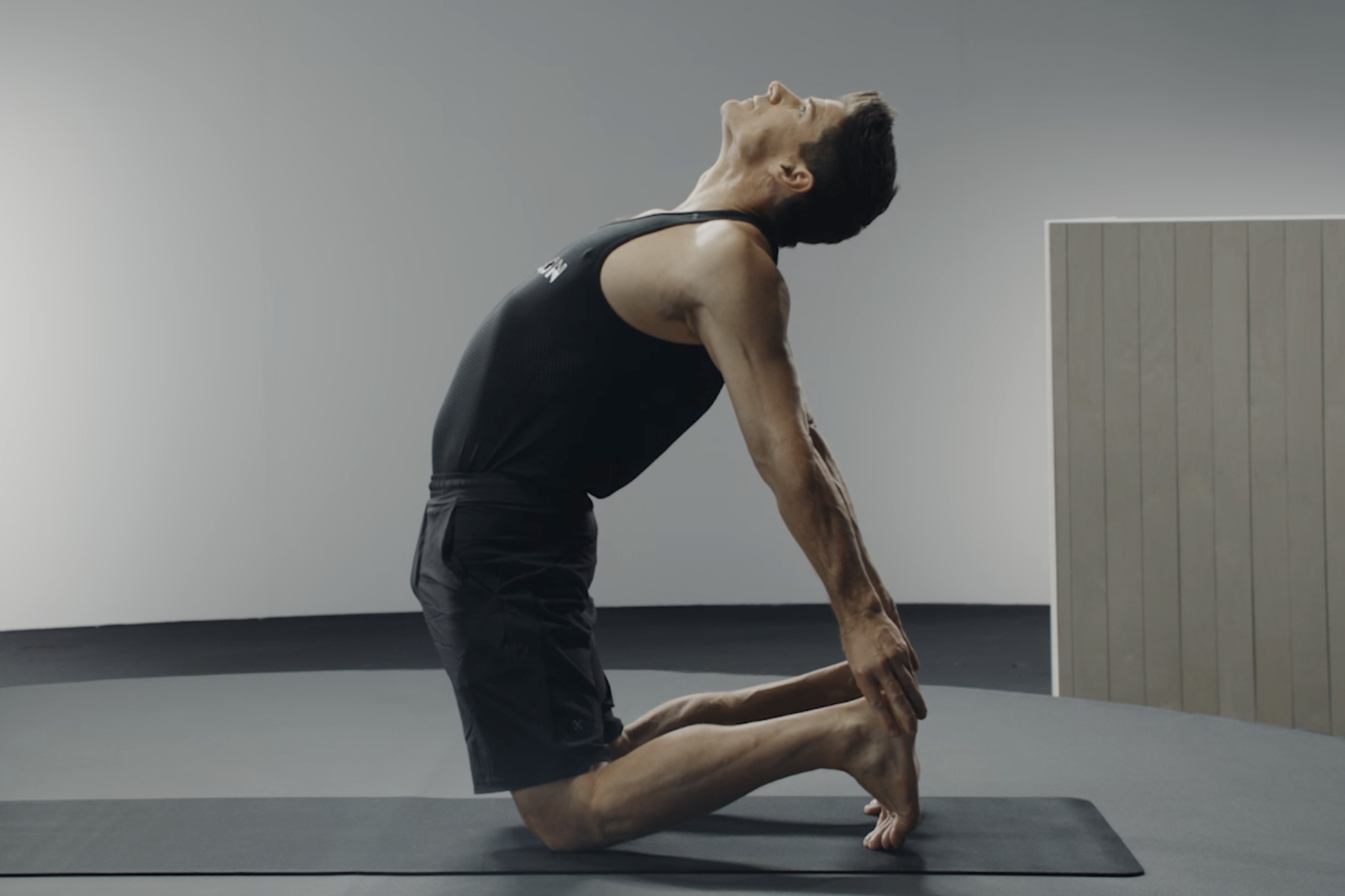 Man does Camel Pose, heart-opening yoga pose