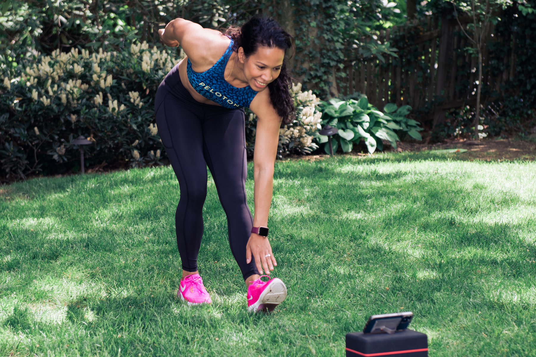 Woman does a hamstring stretch while outdoors 