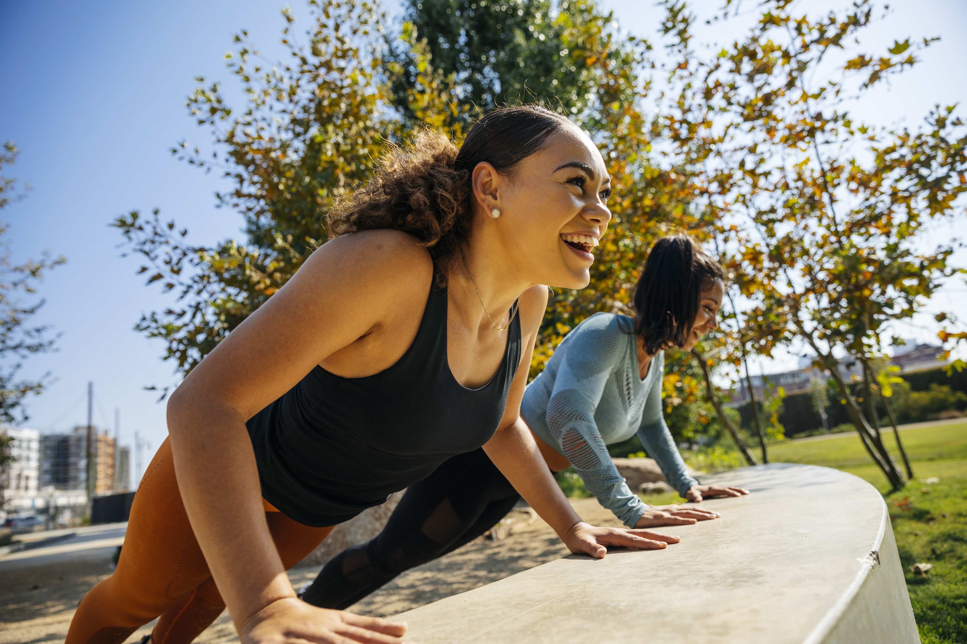 Two women working out together side by side 