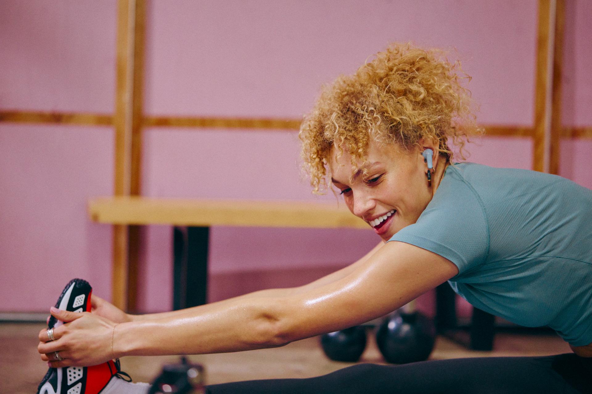 Happy woman completes a feel good workout with Peloton