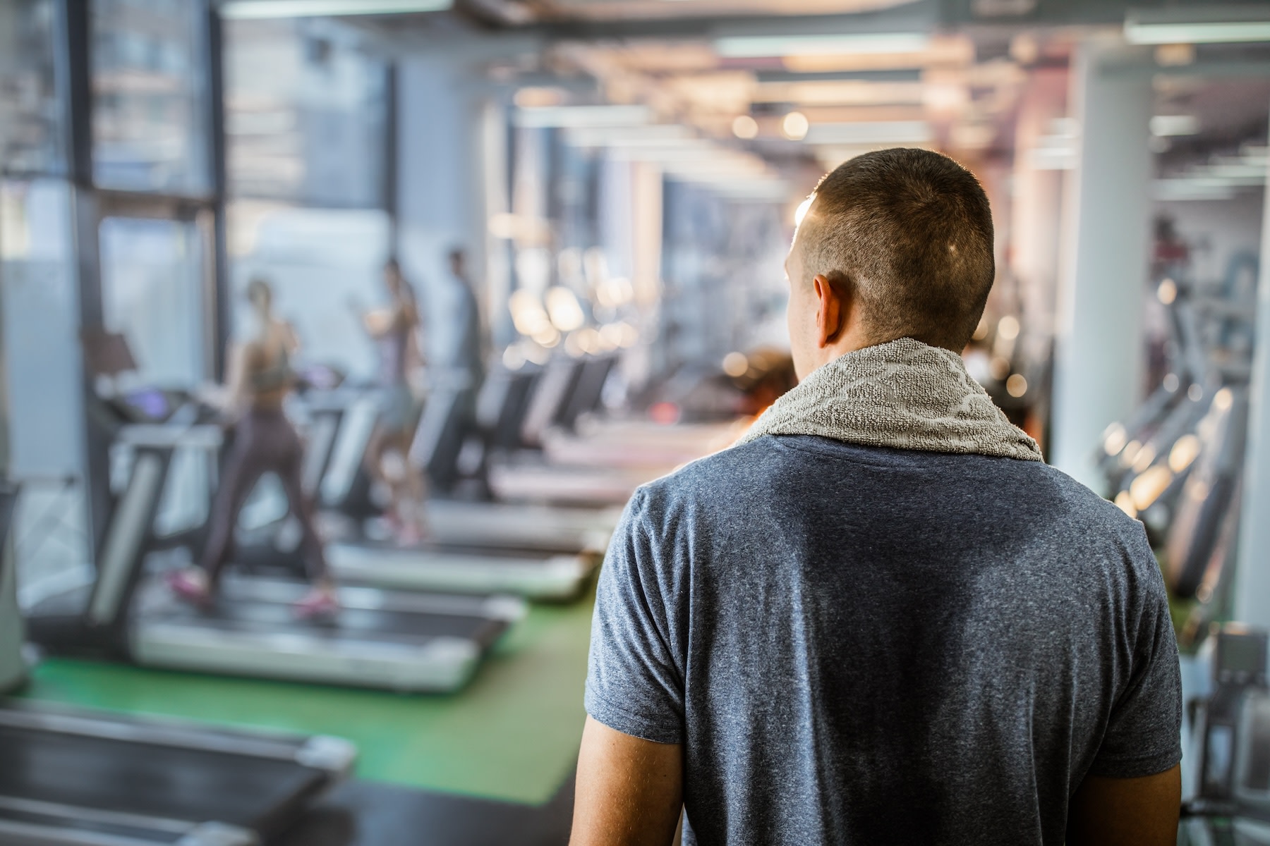Back view of a man looking around the gym.