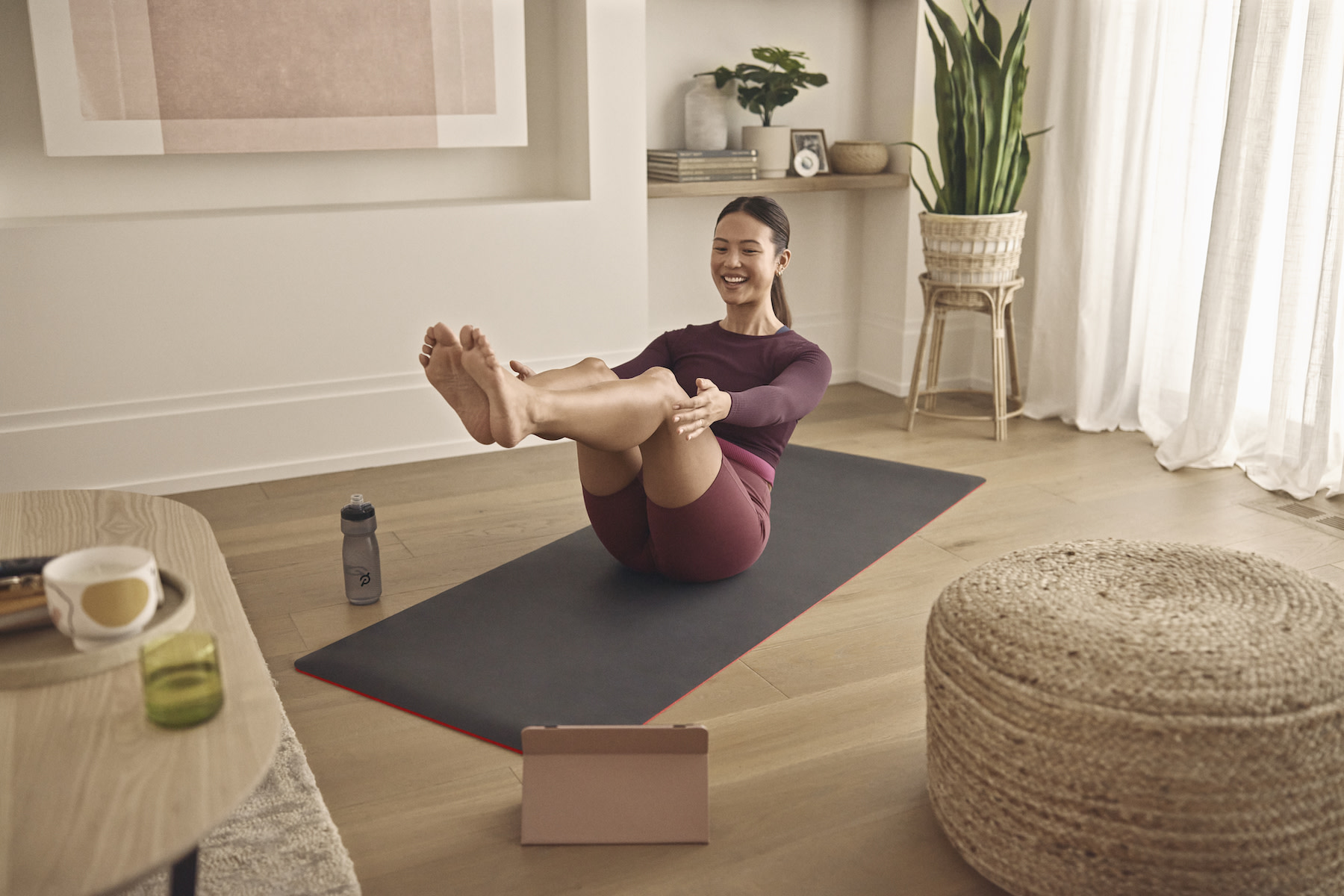 Woman does a workout at home on a yoga mat