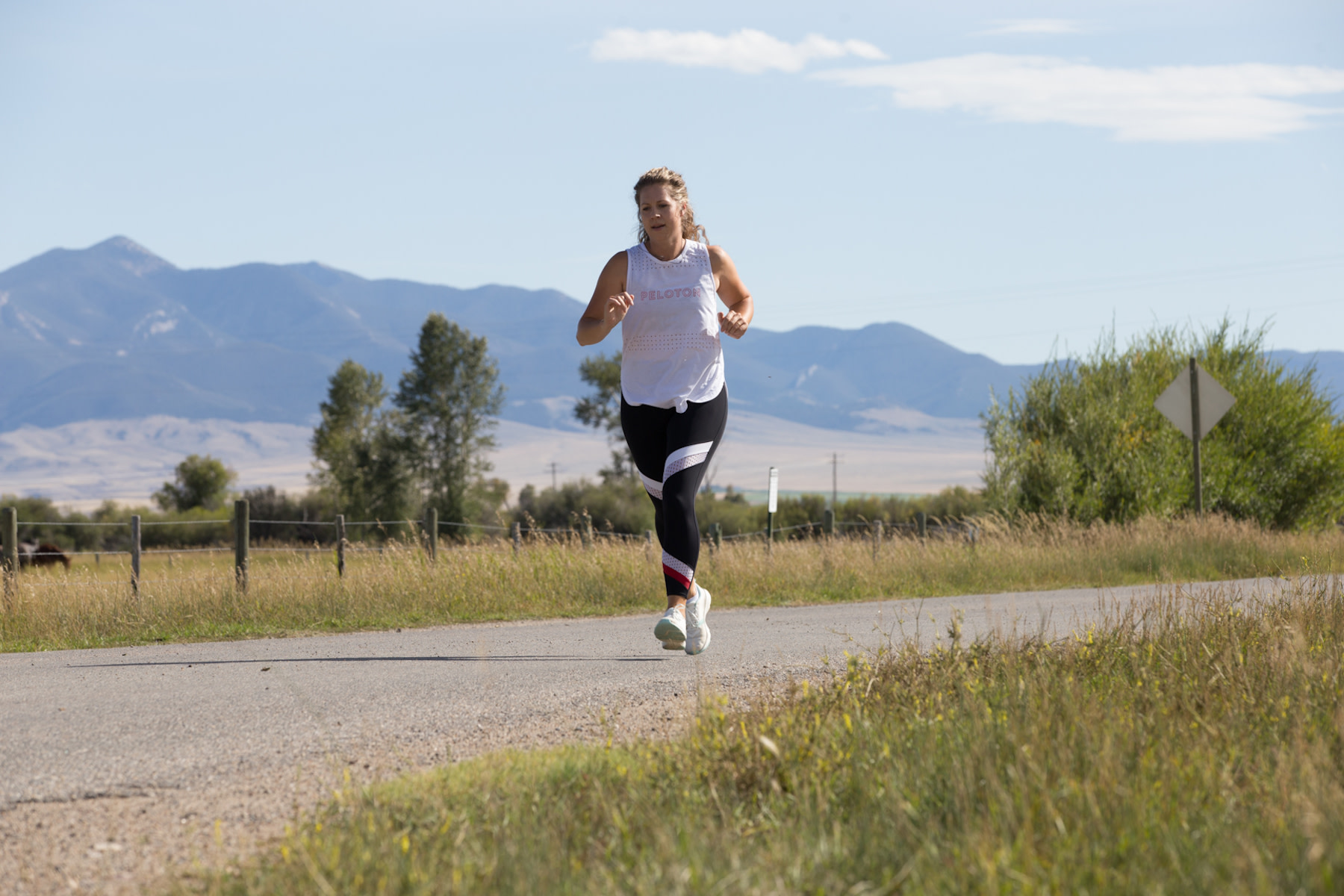 Woman runs on a path outdoors 