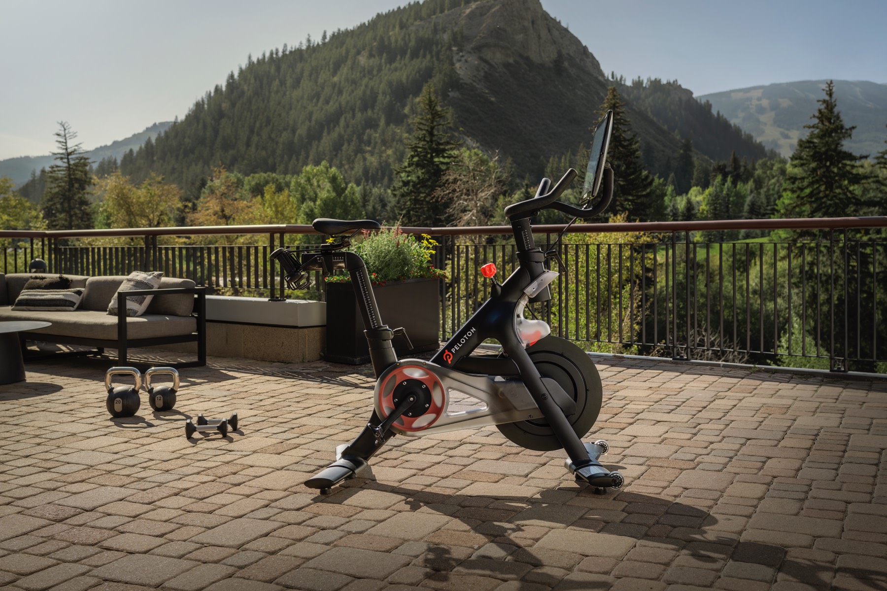 A Peloton Bike on a hotel patio with a mountain in the background