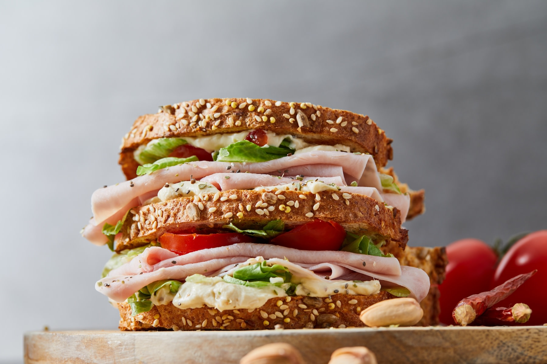 A turkey sandwich with veggies and other toppings.