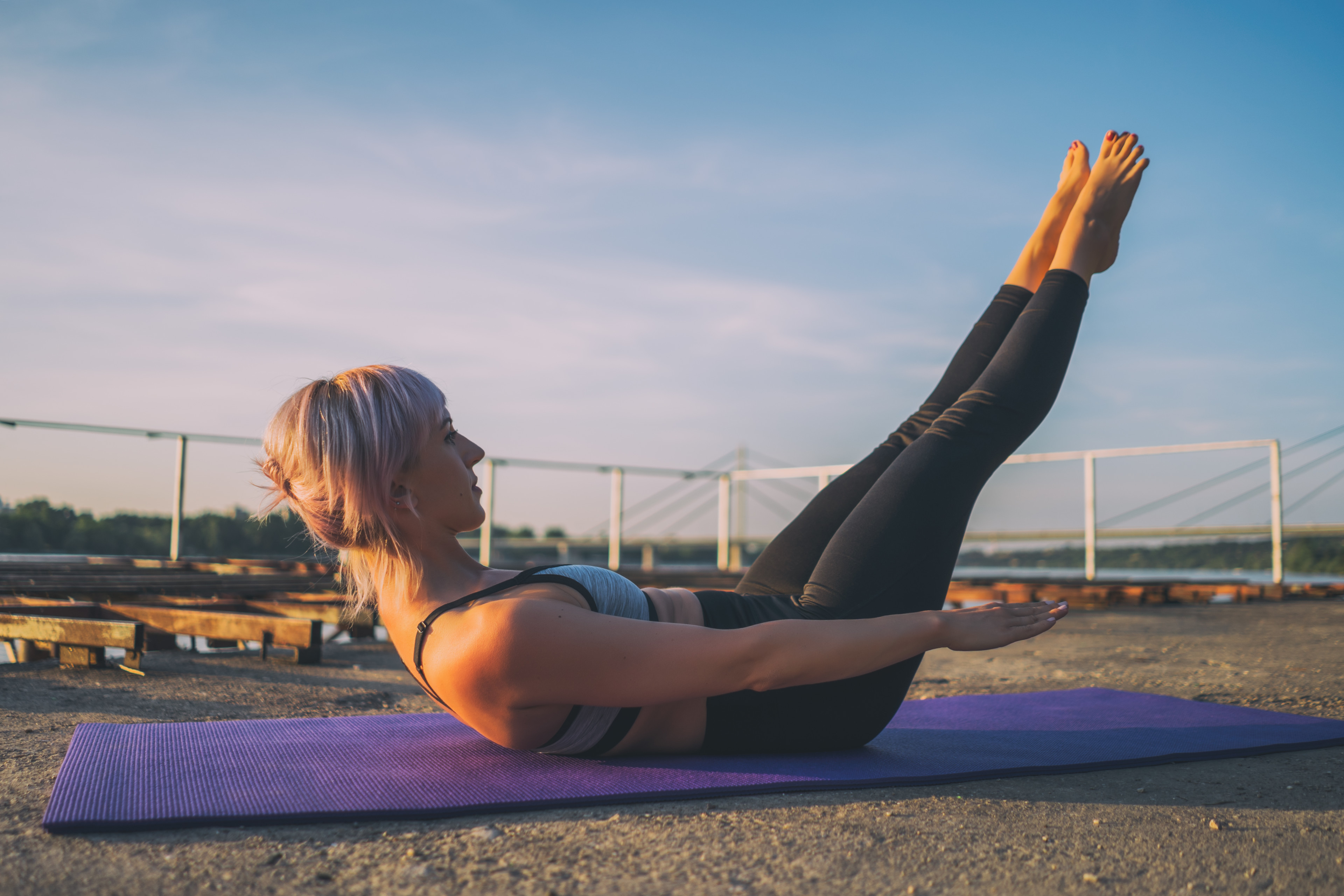 Woman practices Pilates Hundred exercise