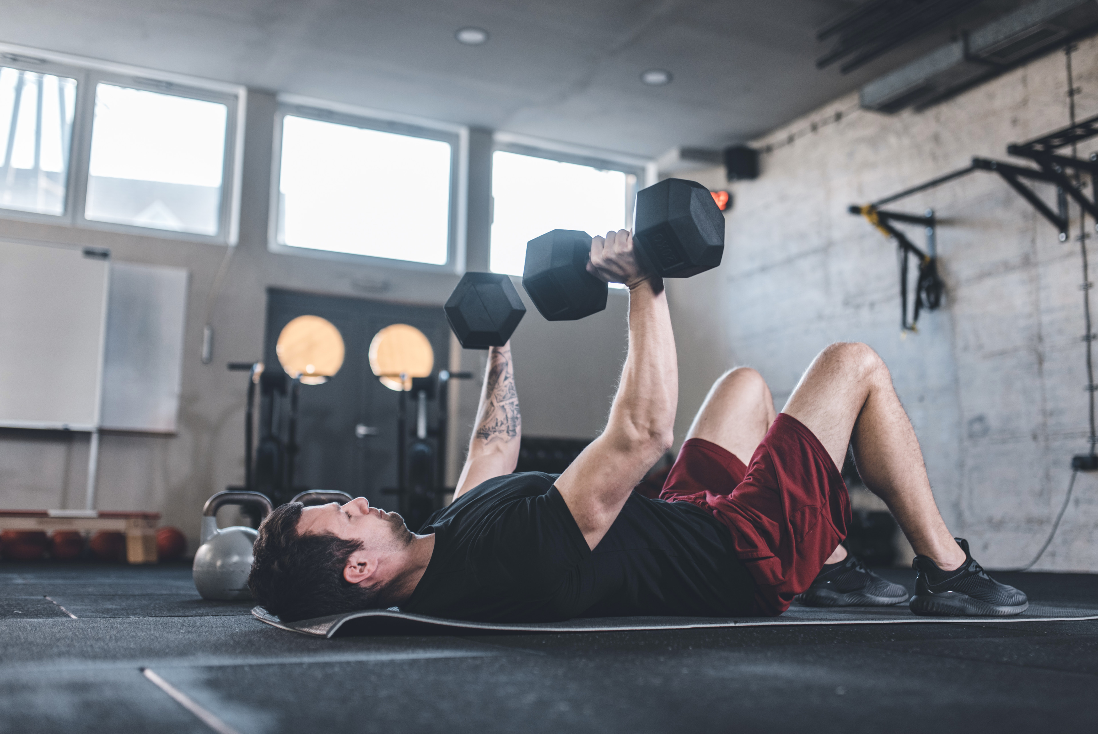 Man does chest exercise with dumbbells