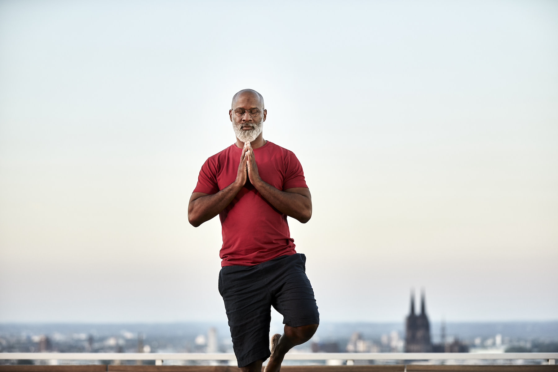 Man stands on one leg to improve his balance